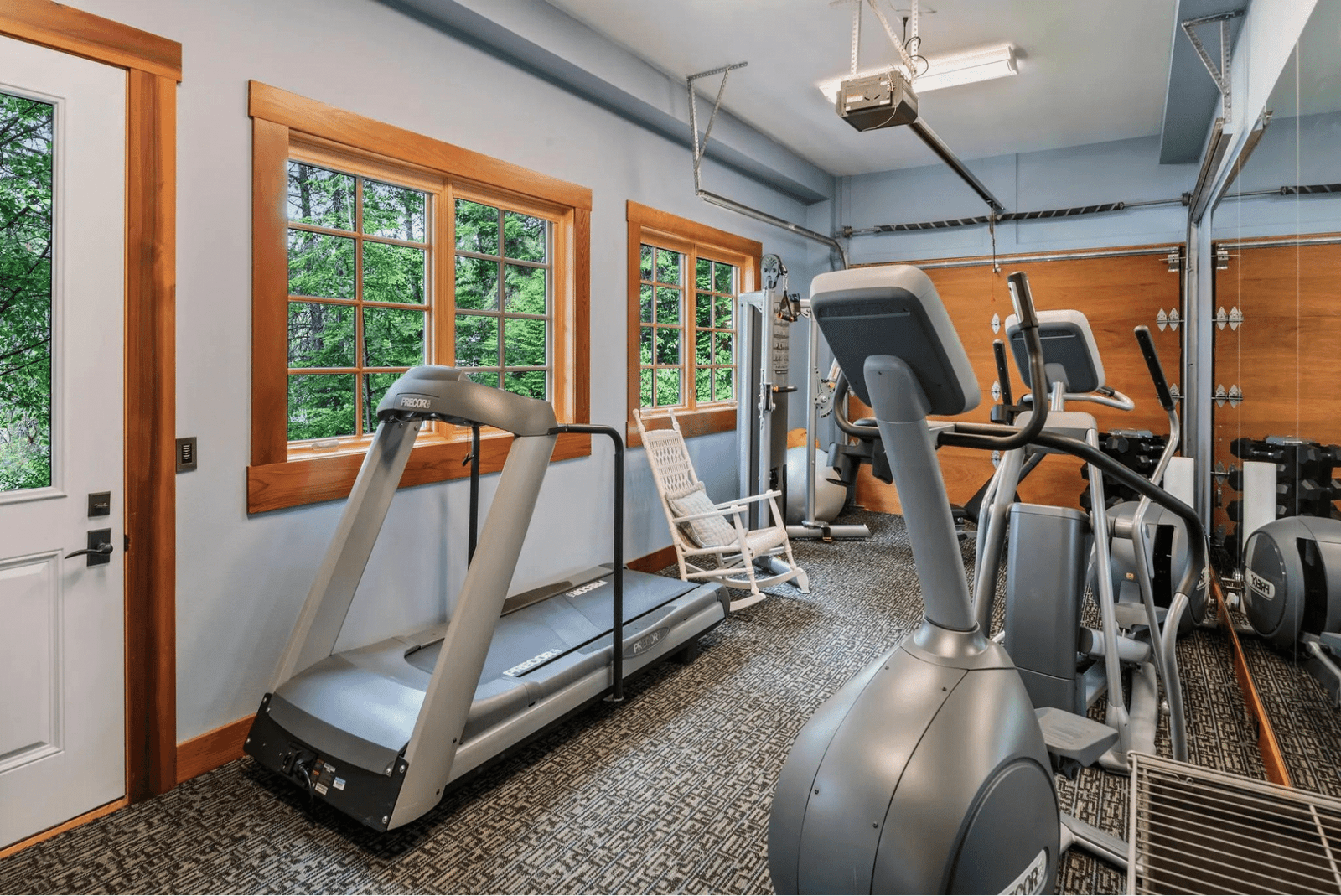 Fitness room with an elliptical, treadmill, and weights